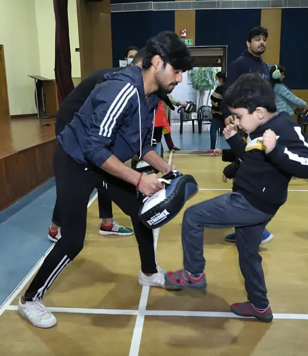 A young warrior learning how to deliver a proper kick. My kids' classes focus on building fundamental skills in a safe and encouraging environment.