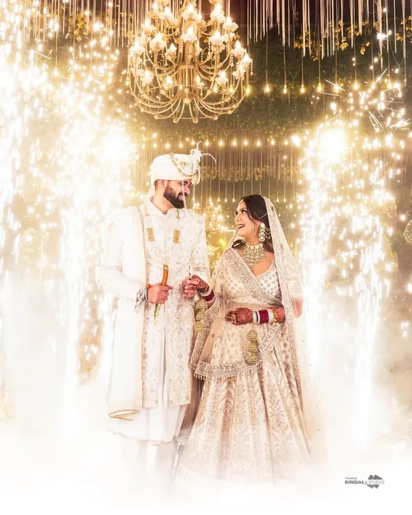 A grand entrance for a fairytale beginning. I use elements like sparklers and smoke to create a truly cinematic moment as the couple walks in, surrounded by the warmth and joy of their loved ones.