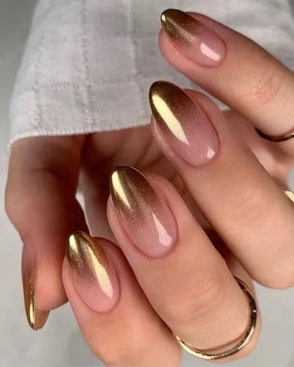 A glimpse into the artistry we deliver. This stunning gold chrome and nude ombre design showcases a modern, elegant finish for a sophisticated look.