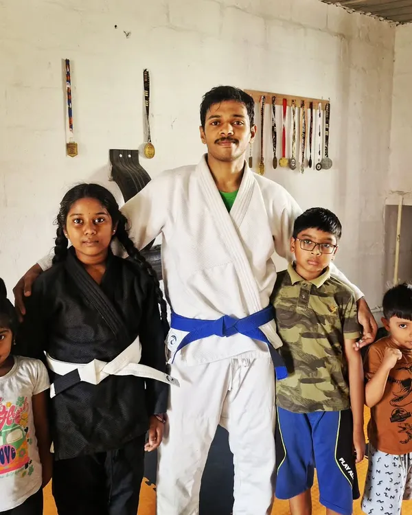 I believe martial arts education is essential for kids. Here I am with some of my young students in their BJJ gis. We offer both group and private classes to help them on their journey.