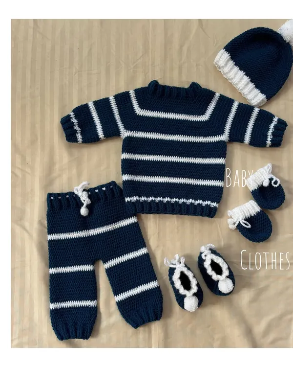 A beautiful flat lay of our complete navy and white striped winter baby set. This five-piece collection is one of our bestsellers and makes for a truly special baby shower gift.