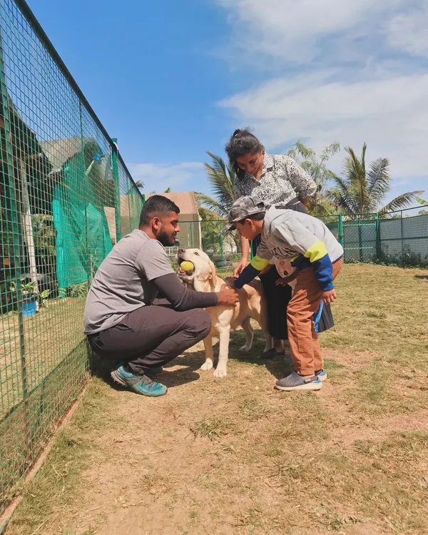 A scene from our 'Kids and Canines Classroom'. Here, one of our trainers guides a child on how to properly interact with a dog, teaching empathy and safe handling from a young age.