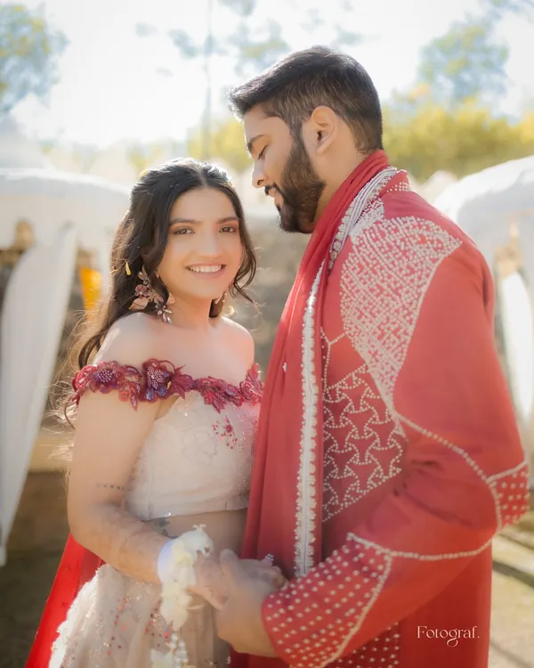 A quiet moment amidst the fun of the Haldi ceremony. The couple shares a gentle look, a calm island in a sea of yellow.