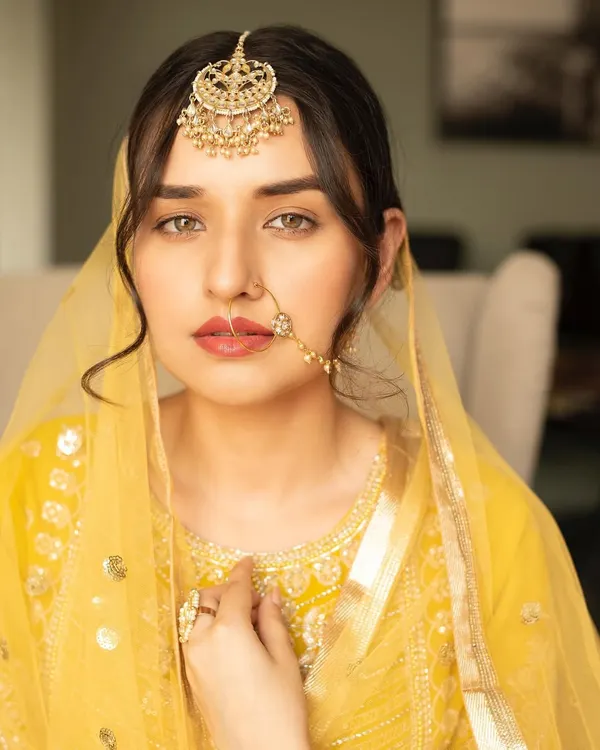 A beautiful Heeramandi-inspired look. I created a dewy, royal makeup look with defined eyes and a soft lip, paired with a classic low bun and face-framing tendrils.