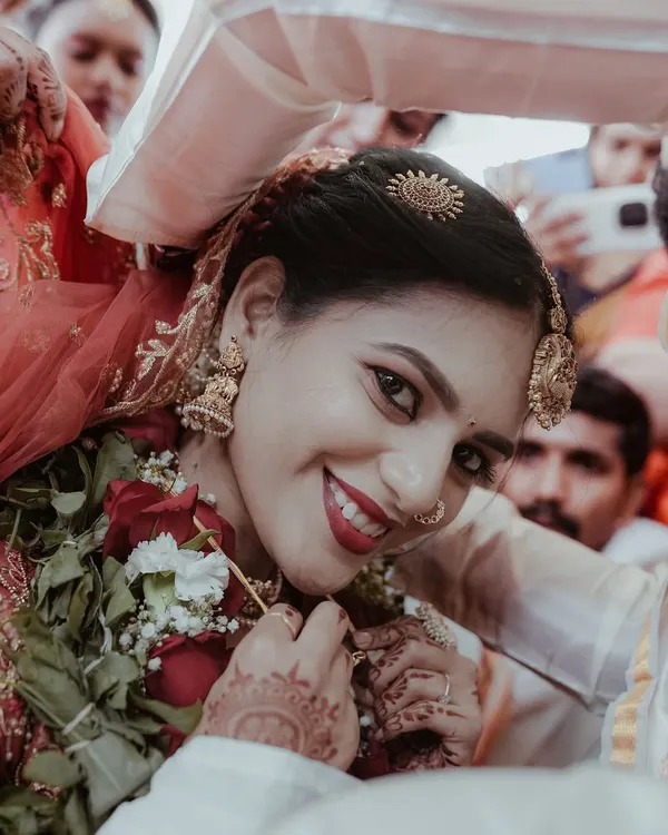 A beautiful close-up of the bride's radiant smile as she's welcomed by the groom's family. This is a perfect example of the happy, candid moments I look for during a wedding.