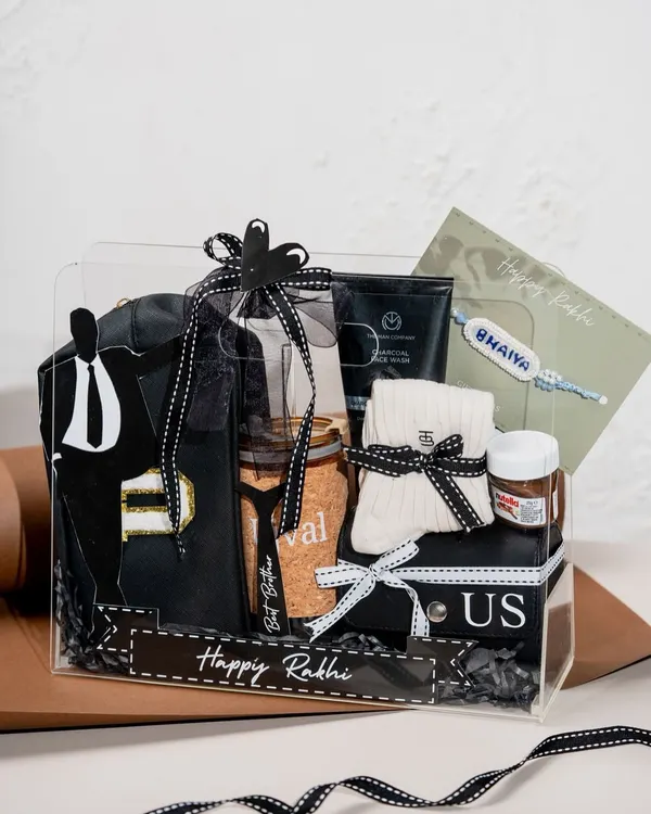 Our Classic Black Box is a bestseller for Raksha Bandhan. This bespoke hamper for brothers includes a custom-designed t-shirt, grooming products, and treats, all elegantly packed in a clear acrylic box.