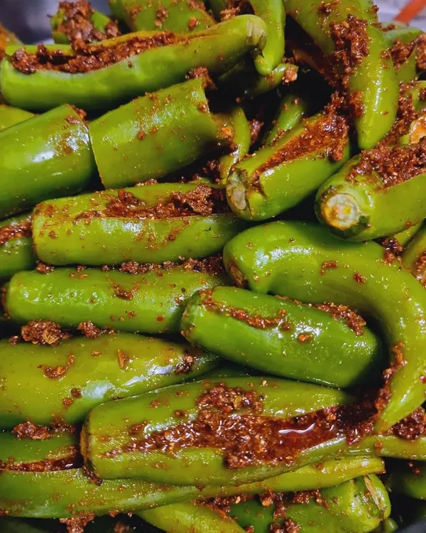 This is my Bharwa Hari Mirch achaar. I carefully stuff each fresh green chili with a flavourful masala mix that is spicy but not overpowering. It's a real treat for those who love a bit of heat.