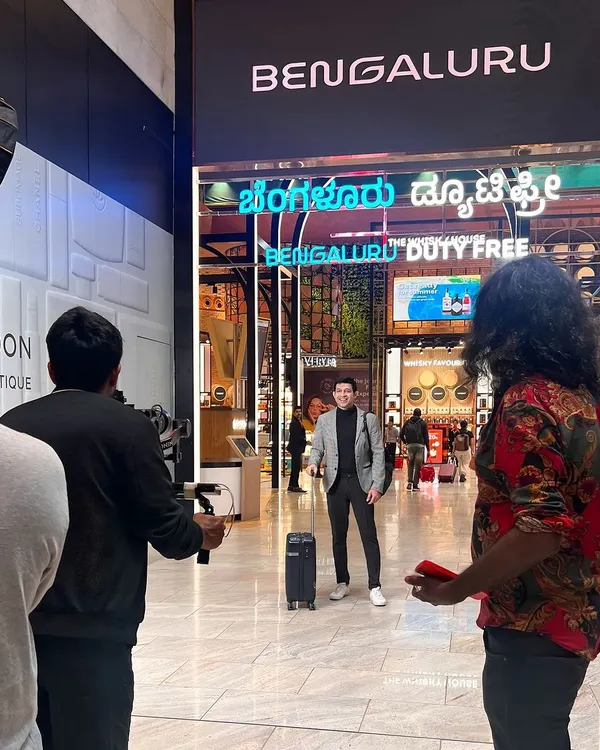 Here I am on set at Bengaluru International Airport for a multi-day ad shoot. This shot shows the scale of the production, with the crew setting up for a scene in the duty-free area.