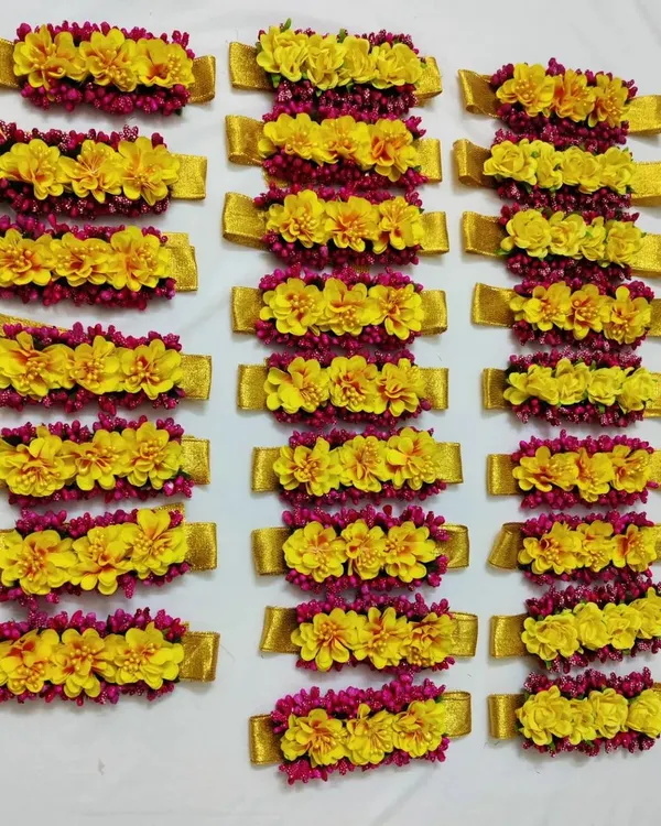 These vibrant yellow and pink floral bracelets are perfect for the bridesmaids at a Haldi or Mayoon ceremony. They add a pop of color and unify the whole bride tribe.