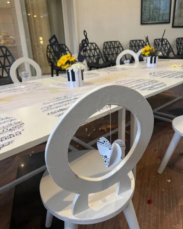 Every detail is designed with intention. For this music-themed party, even the chairs had a special touch, with hanging paper hearts made from musical sheets.