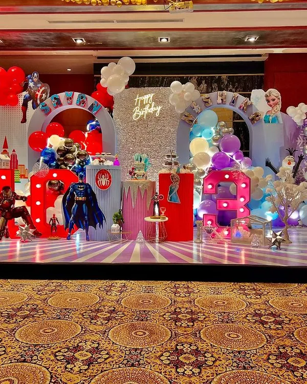 This is what happens when two worlds collide for a joint birthday party. I designed a magical fusion theme, combining the action of superheroes for a 'man in the making' and the icy elegance of Frozen for a 'diva', ensuring both birthday stars felt celebrated in their own unique way.