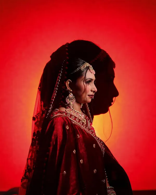 A highly artistic and creative bridal portrait using shadows. The silhouette of the groom's face is cast upon the bride, symbolizing their union in a visually stunning and unique way. This is an example of my signature conceptual shots.