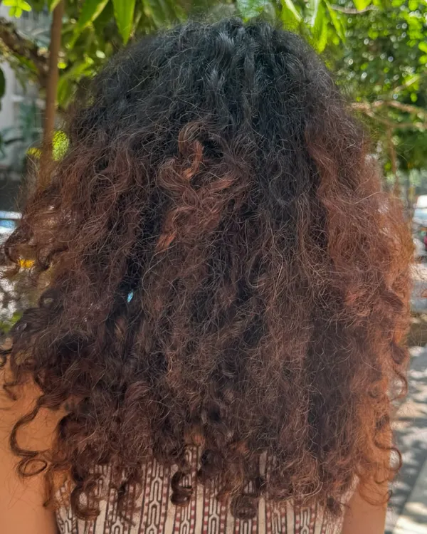 Before: The hair is healthy but lacks dimension, causing the curls to appear less defined.