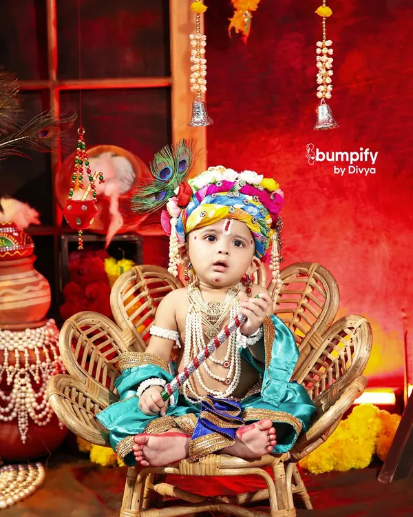 "Maa ki godi mein chhota Gopal, Bumpify ne banaya yeh pal kamaal." This little Krishna looks absolutely divine in a detailed costume, seated on a wicker throne for his Janmashtami portrait.