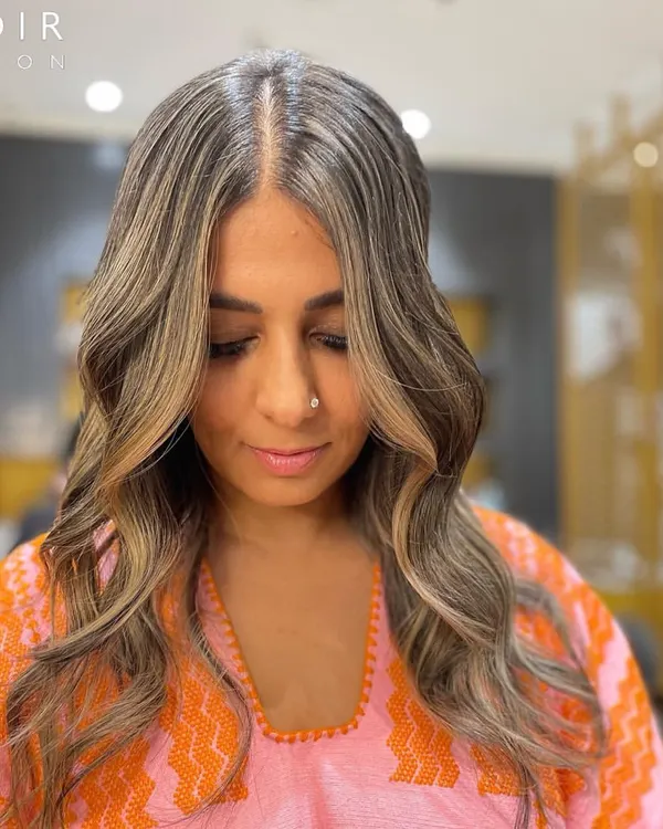A Monday Makeover feature. This client is rocking a cool-toned balayage with beautiful ash and beige highlights that perfectly frame her face.