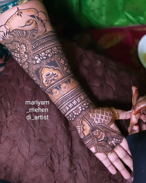 An intricate Maharashtrian bridal design featuring traditional motifs like the swastika and kalash.