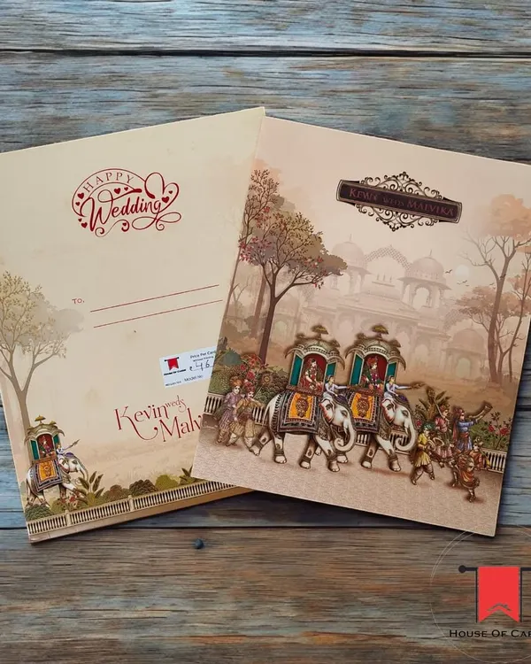 Announce your wedding with the grandeur it deserves. This invitation features a classic Raja-Rani theme, depicting a royal procession with elephants, perfect for a traditional Indian ceremony.