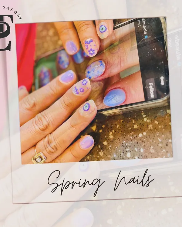 A fun and trendy spring nail design that was created based on a client's reference photo. This set features a mix of pastel purples, delicate floral patterns, and a protective evil eye symbol for a personalized touch.
