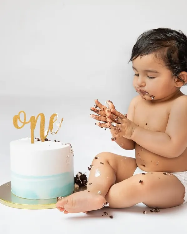 Getting hands-on with the first birthday cake. These are the unscripted, beautifully messy moments that tell the real story of turning one.