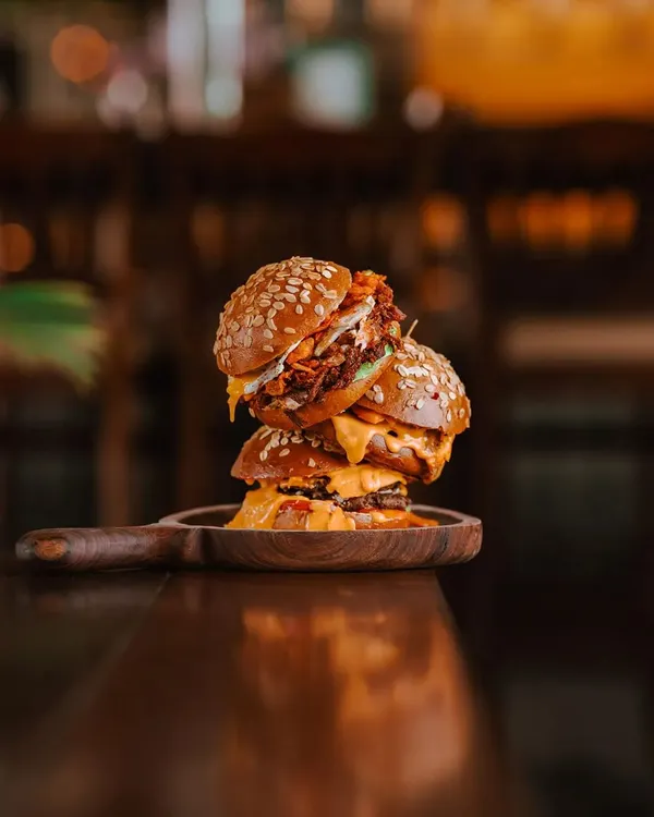 Here is a troika that never fails to win hearts. The hickory smoked pulled pork, the savory smashed lamb, and the classic smashed beef onion burger. Time slows down, flavors pop, and the simple joys of life unravel with each bite.