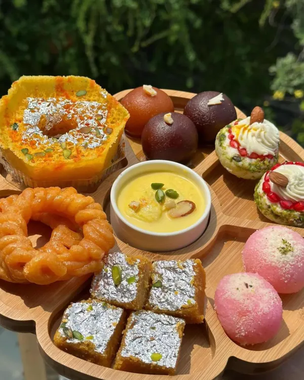 This is my special Indian dessert platter, perfect for finishing a meal on a sweet note. It features a variety of traditional sweets, including Ghewar, Gulab Jamun, Barfi, and Jalebi, all made fresh with quality ingredients.