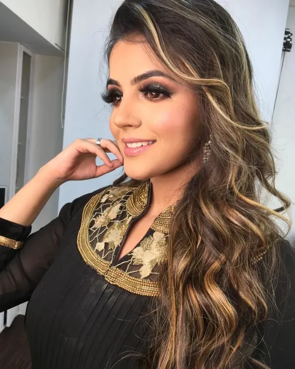 A perfect example of a party glam look. The smokey eye, defined brows, and contoured features are ideal for an evening event or reception.