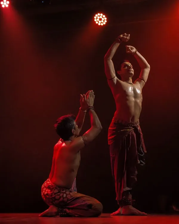 A powerful pose from 'ATAH' where Adithya PV and I move as one. The red lighting adds to the intensity and passion of the performance.