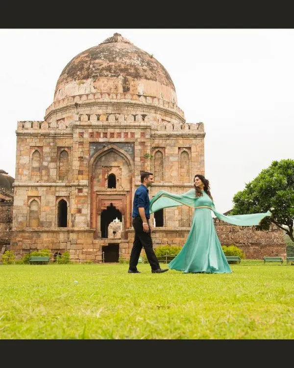 A grand, cinematic shot at Lodhi Garden in Delhi. Using historical monuments as a backdrop adds a sense of timelessness and scale to pre-wedding photos.