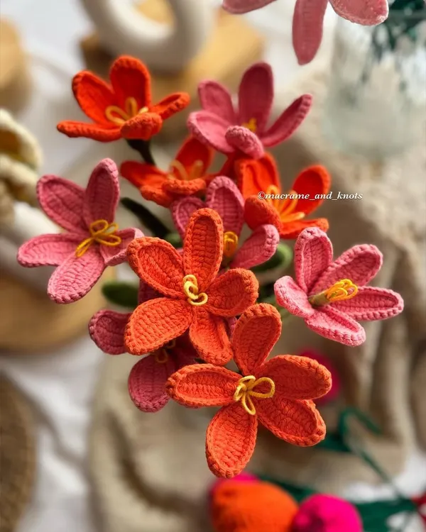 A beautiful overhead shot of the open-petal crochet tulips. The warm tones of orange and pink create a stunning visual, perfect for a vibrant, modern bouquet.