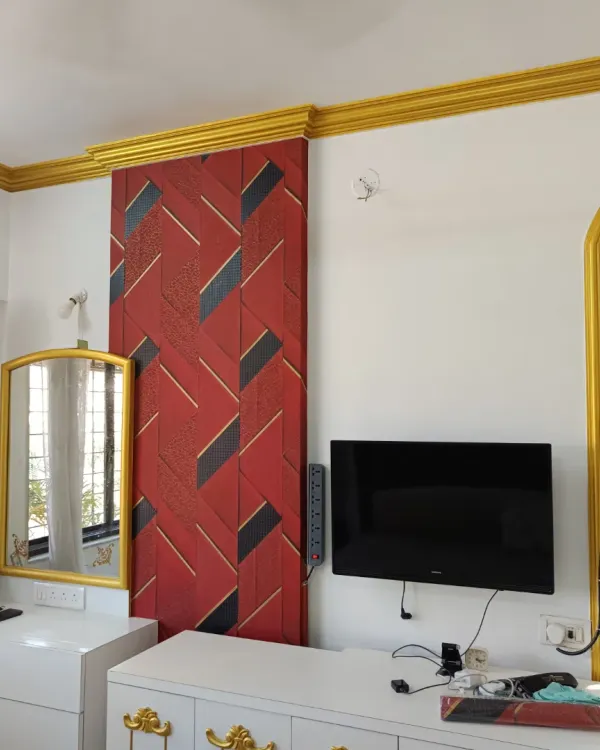 Don't be afraid to go bold. This installation features a striking red and black geometric wallpaper that acts as a powerful focal point in the bedroom. It’s a great example of how a dynamic pattern can energize a room.