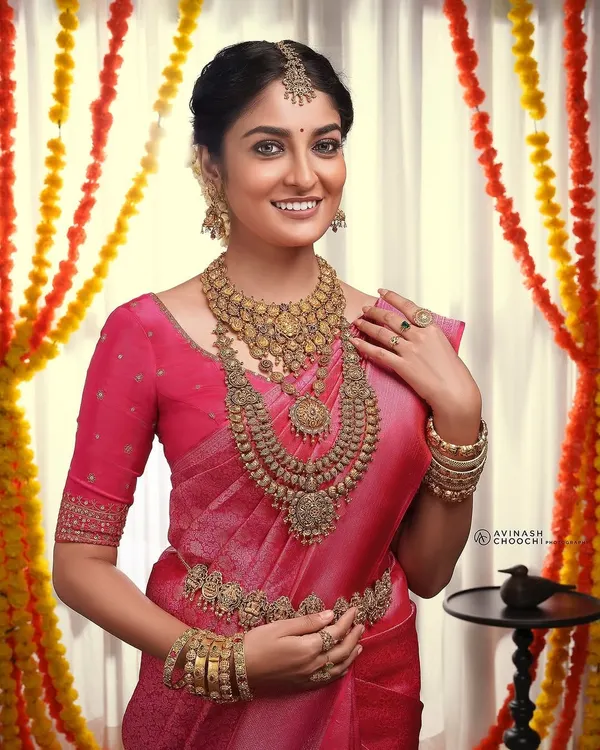 This is the quintessential South Indian bridal look I love to create. For this shoot, I focused on a flawless, radiant base that glows under any light, ensuring the heavy temple jewellery and rich pink silk saree are perfectly complemented. The look is finished with defined eyes and a balanced lip, creating a timeless and photogenic bridal style.