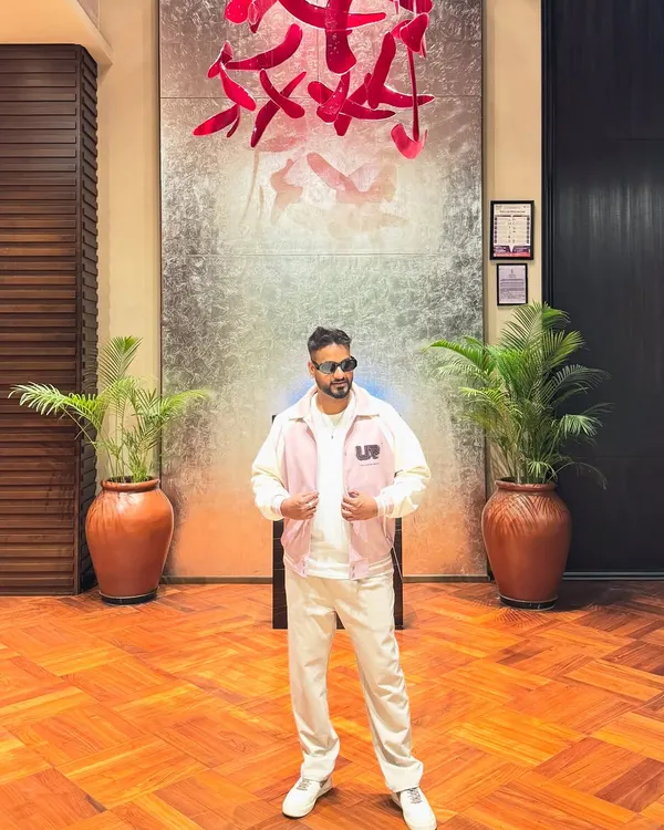 A confident pose in a stylish outfit. The look is an important part of the performance.