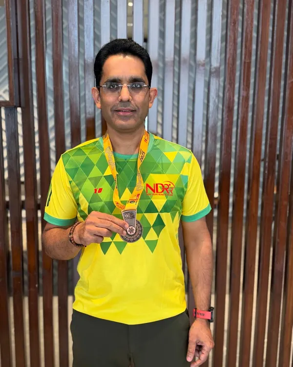 A proud moment for one of our runners, showing off his well-earned medal after a race. Every finish line is a victory.