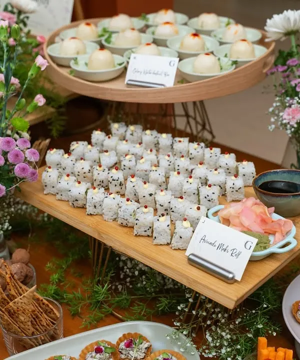 An abundant spread of our Asian-inspired grazing table, featuring Asparagus Maki Rolls and Celery & Waterchestnut Baos. This showcases our ability to cater large events with a diverse and delicious Asian menu.