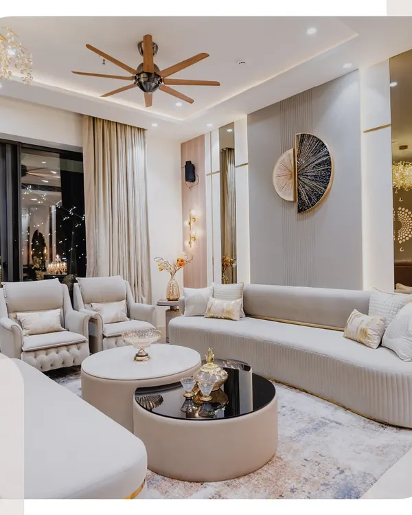 This living room is all about creating a feeling of quiet luxury. I used a curved sofa to soften the space and make it more inviting for conversations. The mix of neutral tones, gold accents, and layered lighting creates a warm, sophisticated vibe that feels like home.