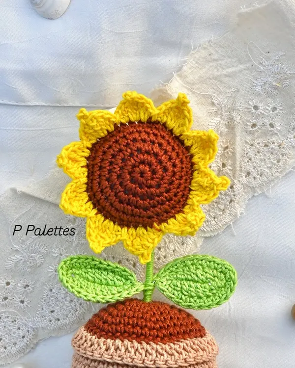 Turning strings into beautiful things. This is a close-up of our adorable potted crochet sunflower, showing the intricate stitch work.