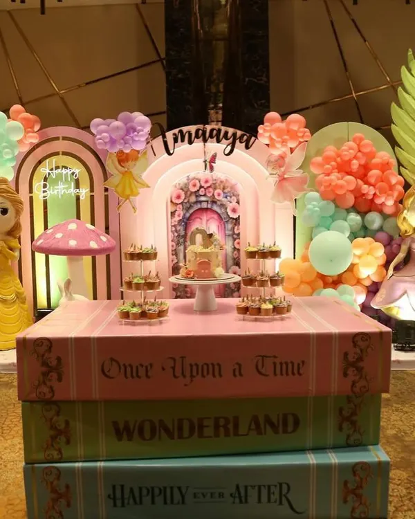 This is what we mean by a dessert table that tells a story. For a magical "Wonderland" birthday, we designed the entire display to look like a stack of giant storybooks, creating an immersive experience with a beautiful cake and matching cupcakes.
