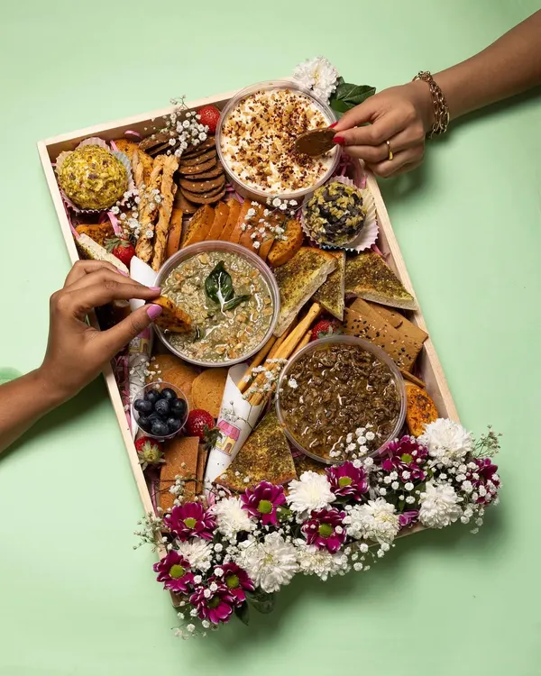 This is what I call a party-starter. My 'All In' grazing tray is packed with a variety of my best dips, cheese domes, fresh fruits, and baked-to-order sides, all beautifully arranged with fresh flowers. It's perfect for Diwali parties, card games, or any festive get-together.