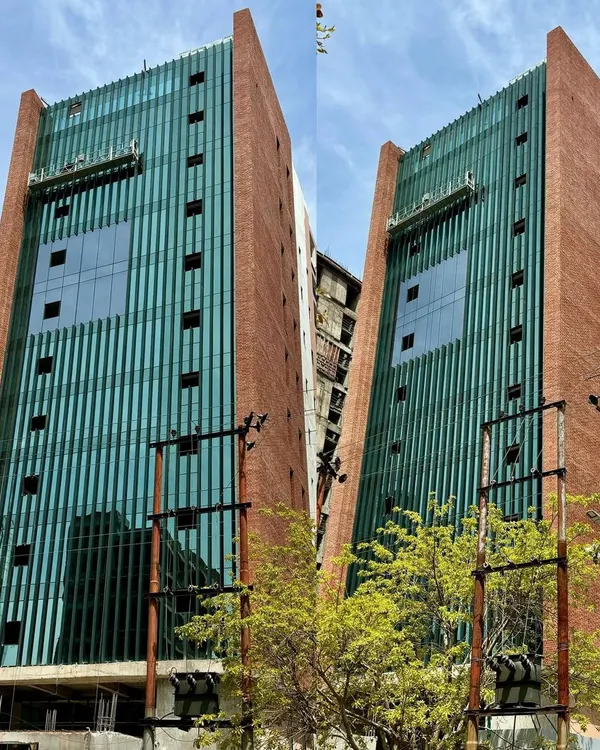 This facade demonstrates our core belief in the harmony of materials. The warmth and texture of exposed brick provide thermal mass and a sense of permanence, while the sleek glass curtain wall invites natural light, creating an office environment that is both stable and inspiring.