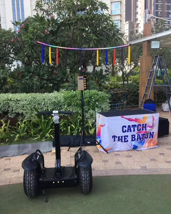 I provide unique entry ideas and fun activities for any event. This setup shows my 'Catch the Baton' game alongside a Segway, a combination that's widely preferred for destination weddings and corporate family days in Lonavala, Pune, and Igatpuri.