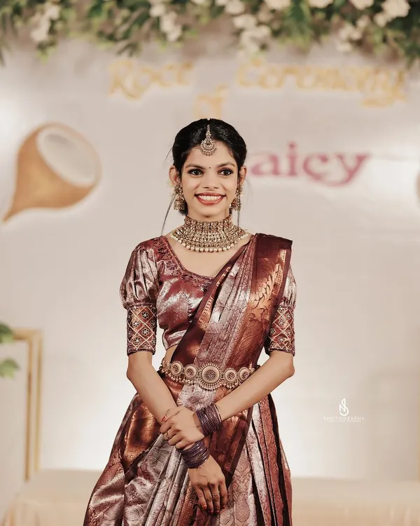 A stunning portrait of a South Indian bride on her wedding day. Her traditional silk saree, intricate jewelry, and happy smile are the focus of this timeless shot.