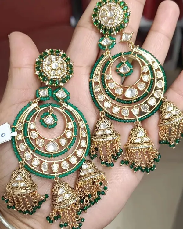 These large chandbali earrings with attached jhumkas are a statement in themselves. Made with kundan and green beads, they are perfect for when you want your earrings to be the hero of your look.