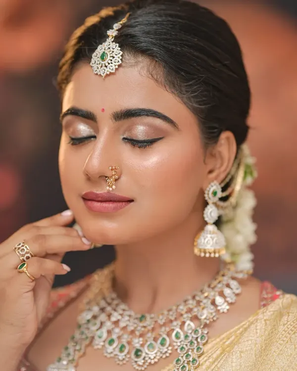 A close-up of a classic South Indian bridal look. Notice the shimmering eyeshadow, sharp winged liner, and the perfectly blended base that gives a radiant glow.