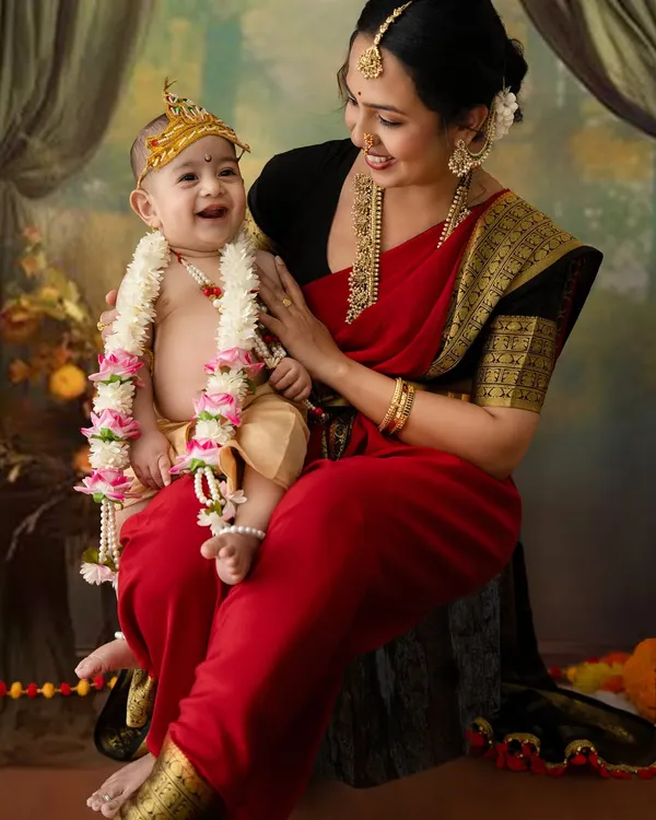 A beautiful, candid moment between a mother and her laughing baby, both dressed in traditional attire for a Janmashtami photoshoot. This is the kind of pure joy I love to capture.