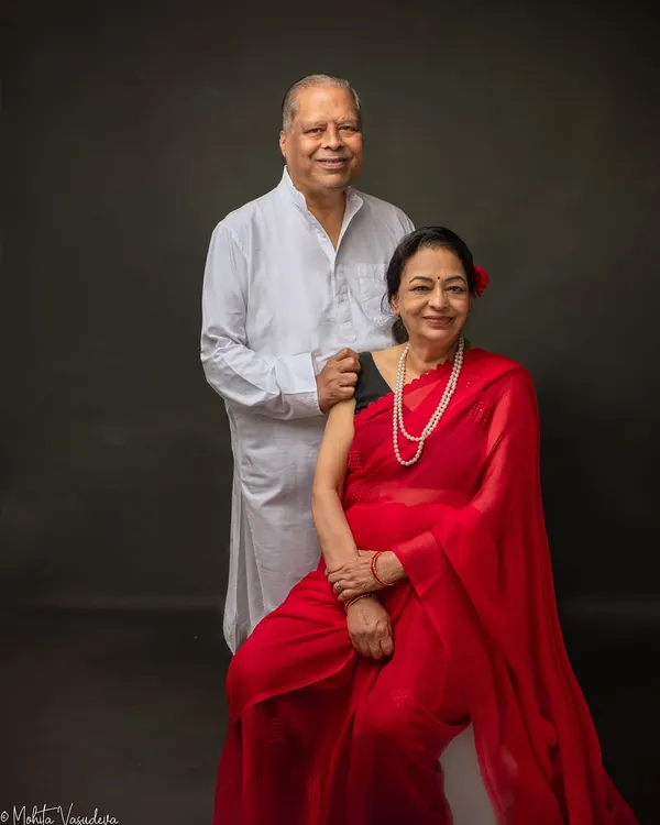 A portrait of my parents, the heart of our family. Capturing them together is a way to honor their legacy and freeze a moment of their love and connection in time. The classic red saree and white kurta create a timeless look.
