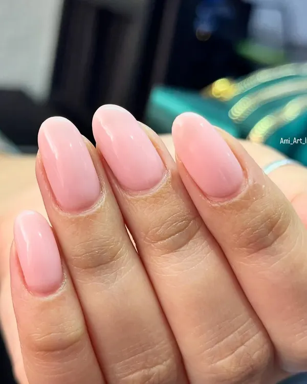 A beautiful, clean set of glossy pink nails for a simple and elegant look.