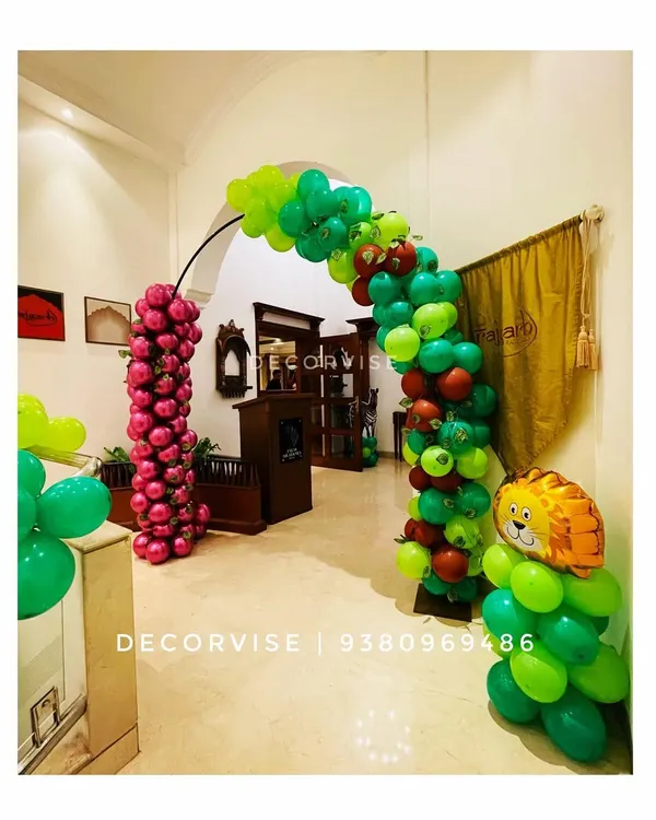 For a jungle-themed birthday, I created this balloon arch to serve as a grand entrance. The combination of different shades of green, pops of red, and a character foil balloon immediately immerses guests in the party's theme.