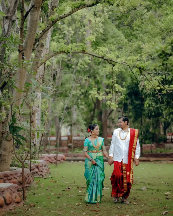 A candid shot of the couple taking a stroll through a lush park after their wedding. This natural, unposed moment captures their easy comfort with each other.
