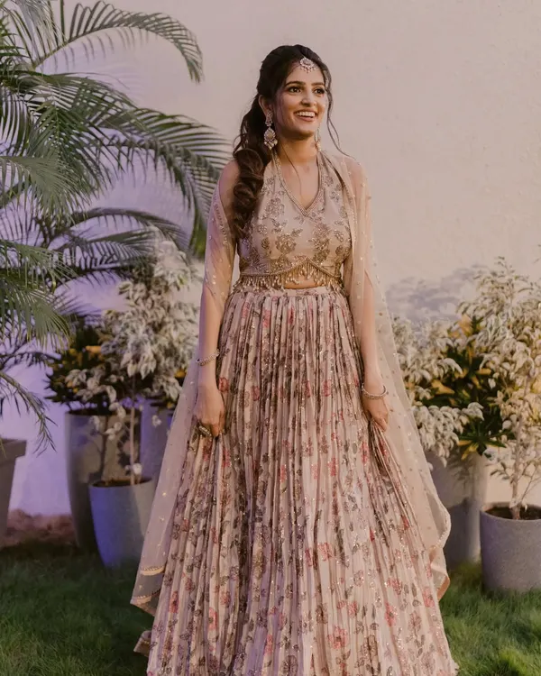 Harini was a dream for her Sangeet. We went with a soft, romantic look with a pop of color on the lips to complement her beautiful floral lehenga.
