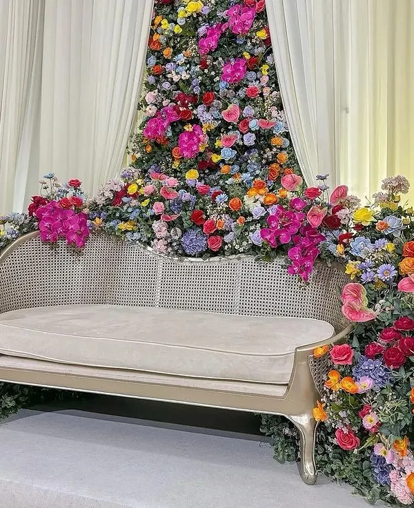 A closer look at the throne of dreams. This angle highlights the intricate placement of dozens of flower varieties, creating a rich texture of colors and shapes around the seating.